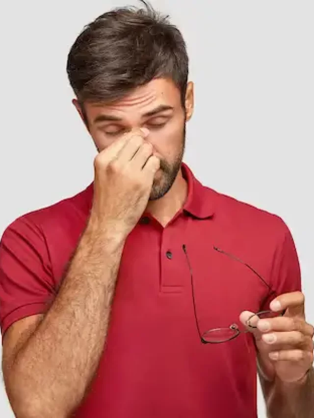 horizontal-shot-overworked-handsome-guy-keeps-hand-nose-takes-off-spectacles-feels-pain-eyes-after-work-computer-wants-sleep-wears-casual-red-t-shirt-isolated-white-wall_273609-16318